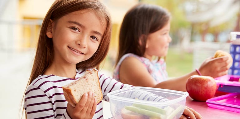 elementary-school-girls-eating-at-school-lunch